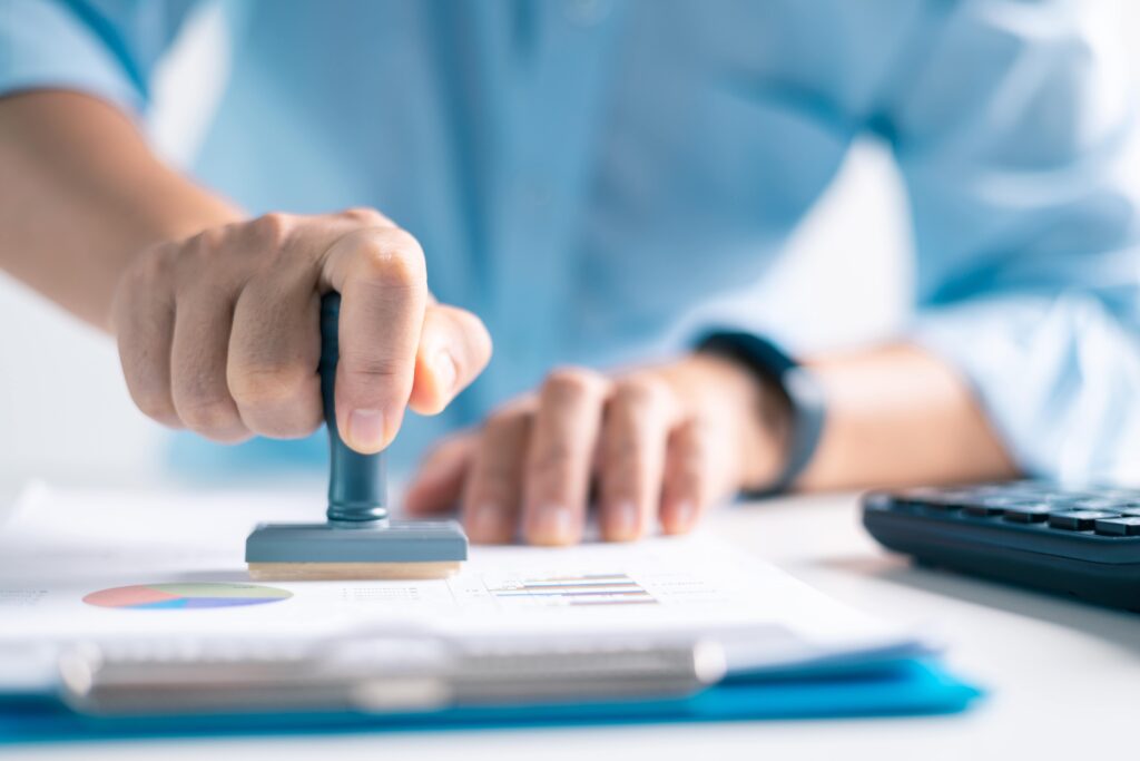 Authorized officer at Link Resources using a pen to formally sign off on a Permit to Work document.