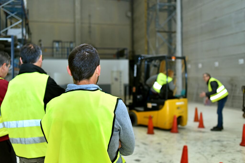 Link Resources forklift licence training students observing forklift operation with safety cones