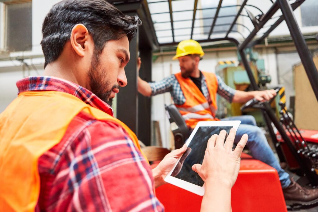 Link Resources forklift licence training workers reviewing safety checklist near forklift