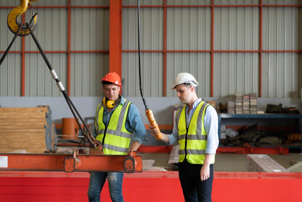 Link Resources overhead gantry crane training workers guiding suspended load in warehouse