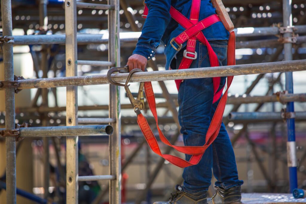 Link Resources working at heights course worker using fall arrest harness on scaffolding structure
