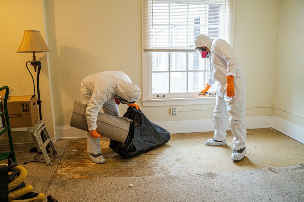 Link Resources remove friable asbestos workers safely removing asbestos material in protective suits