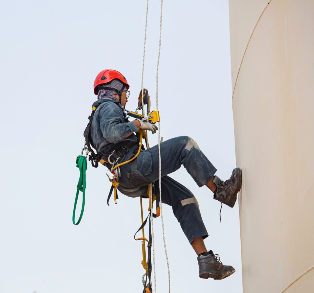 Link Resources working at heights course rope access worker descending building with safety harness