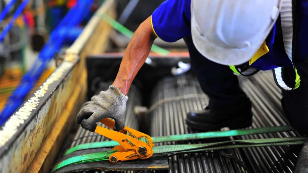 Link Resources load restraint training worker securing cargo with ratchet strap on truck