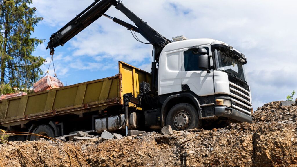 Heavy vehicle with loading crane operating on worksite during Link Resources heavy vehicle verification of competency assessment
