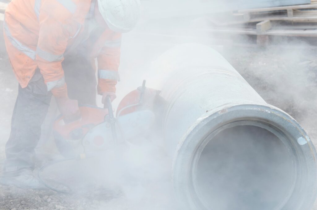 Link Resources 10830NAT Crystalline Silica Exposure Prevention training worker cutting concrete pipe with dust control